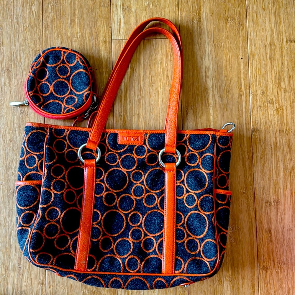 Tumi handbag/business tote made out of grey textile with orange leather patern